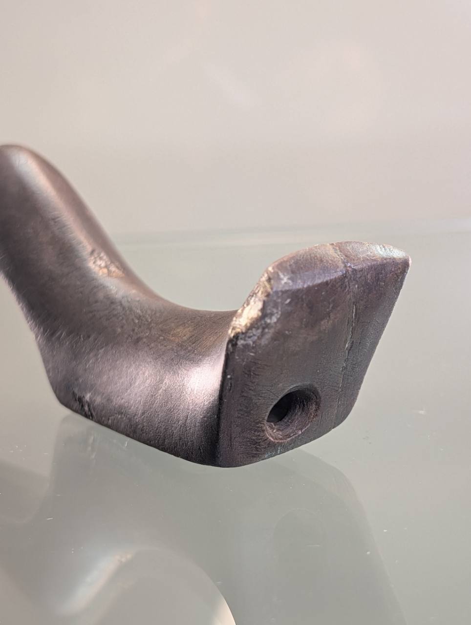 Clermont County birdstone tail detail showing edge chipping and drilled opening