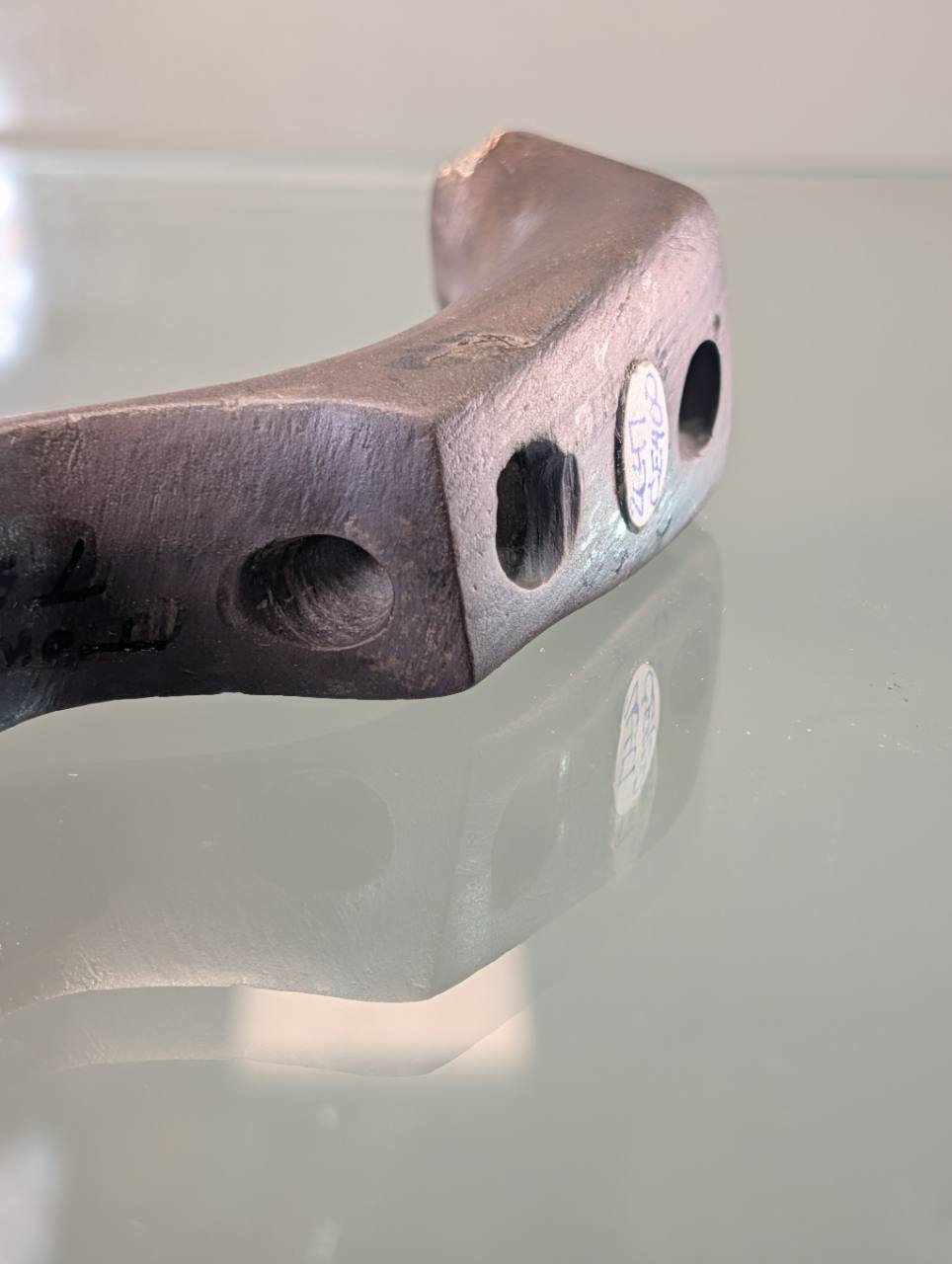 Underside of the Clermont County birdstone showing drilled openings and collector label