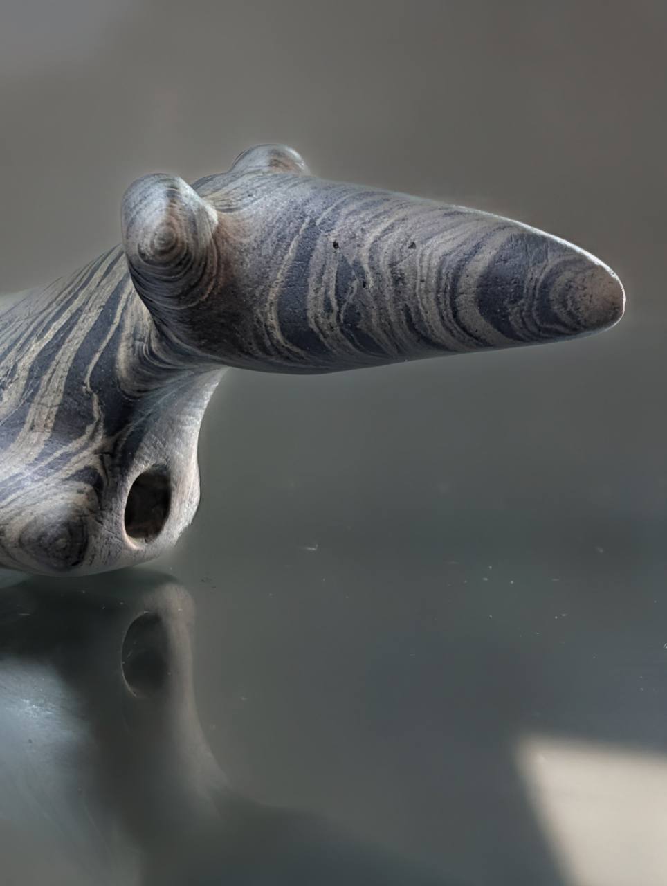 Close view of the Illinois Popeye birdstone's raised eyes and elongated head
